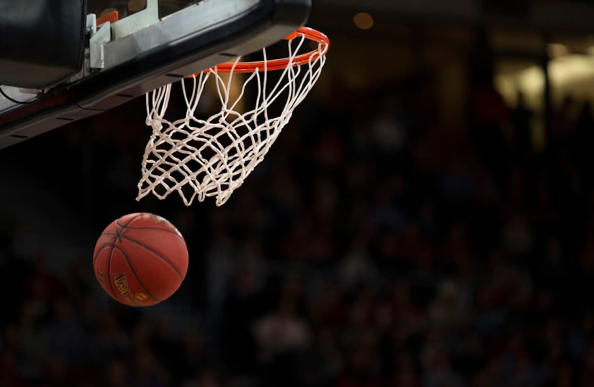 Basketball players in live game action on the court